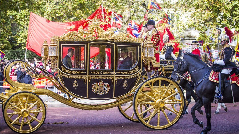 Queen Elizabeth II and China's President Xi Jinping travel together in the Diamond Jubilee State Coach along the Mall to Buckingham Palace in central London on October 20, 2015