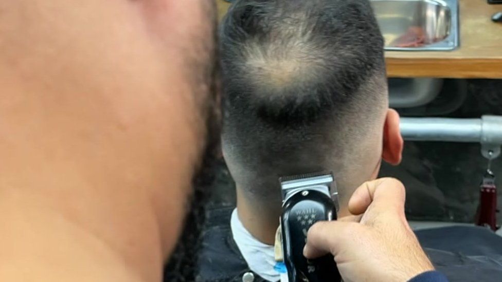 Close up shot of a barber cutting hair