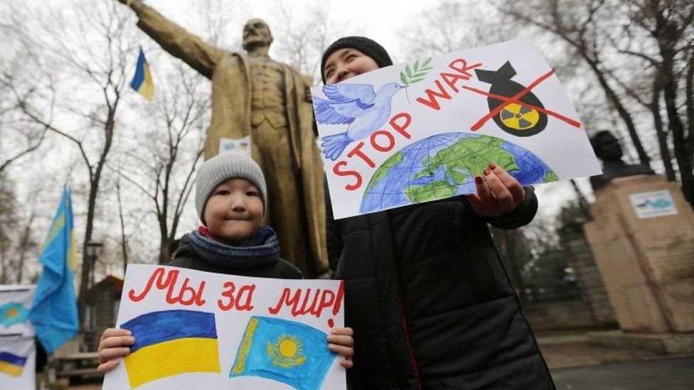 Protesters in Almaty, Kazakhstan, in front of a Lenin statue