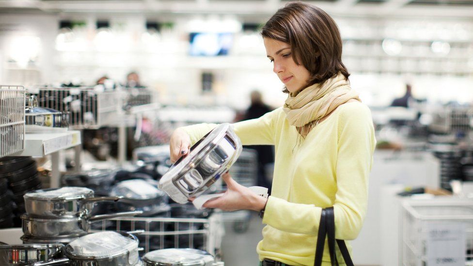 Woman shopping for kitchen pans