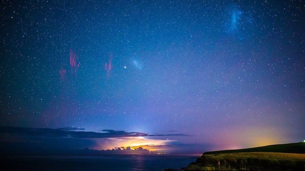 A panoramic image showing a lightning spite and Aurora Australis