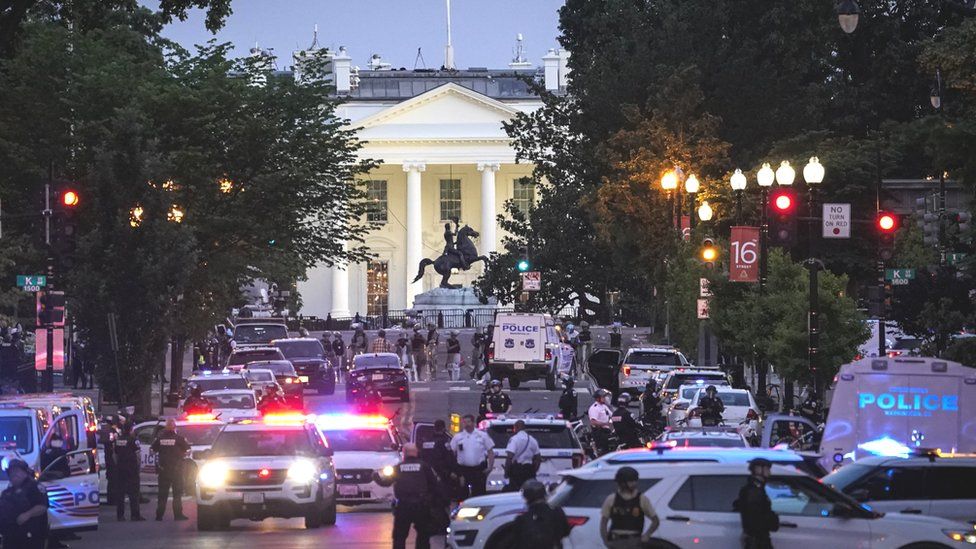 The scene at the White House, showing dozens of police vehicles and a huge presence of armed officers near the building