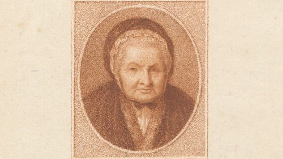 Sepia-tone print of an elderly woman wearing a bonnet