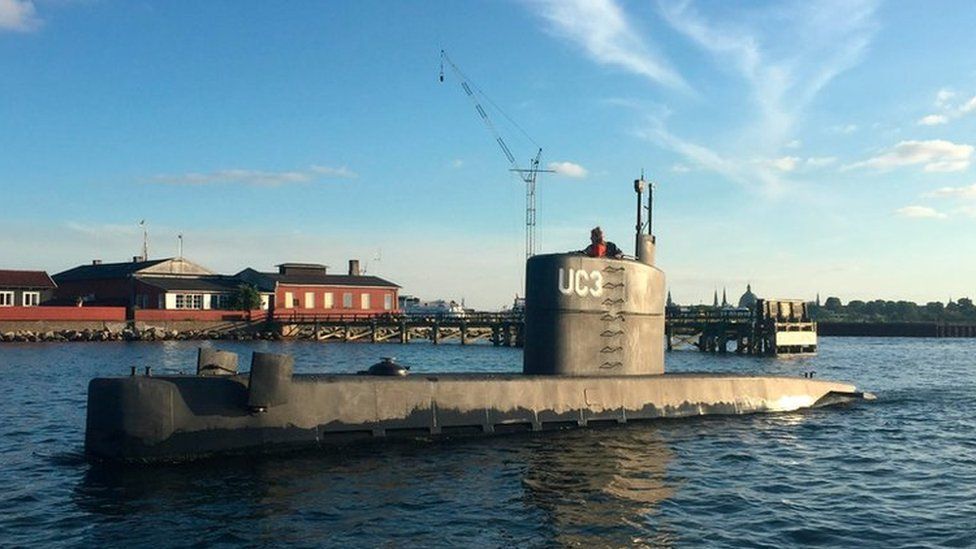 The submarine "UC3 Nautilus", with Kim Wall looking out of the top, is pictured in Copenhagen Harbour