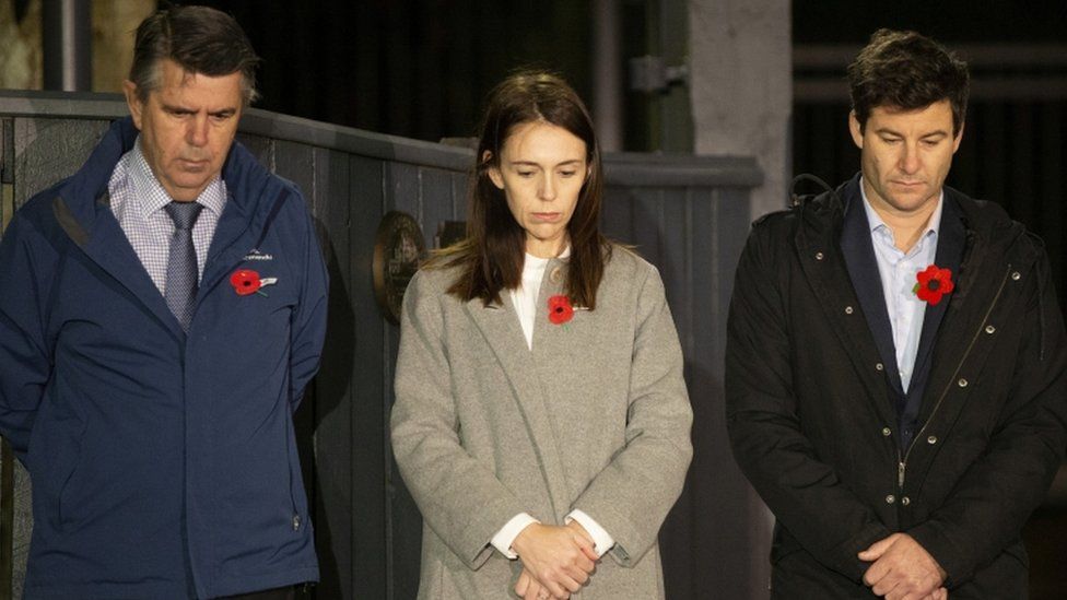 New Zealand Prime Minister Jacinda Ardern stands at dawn on the driveway of Premier House with her husband and father