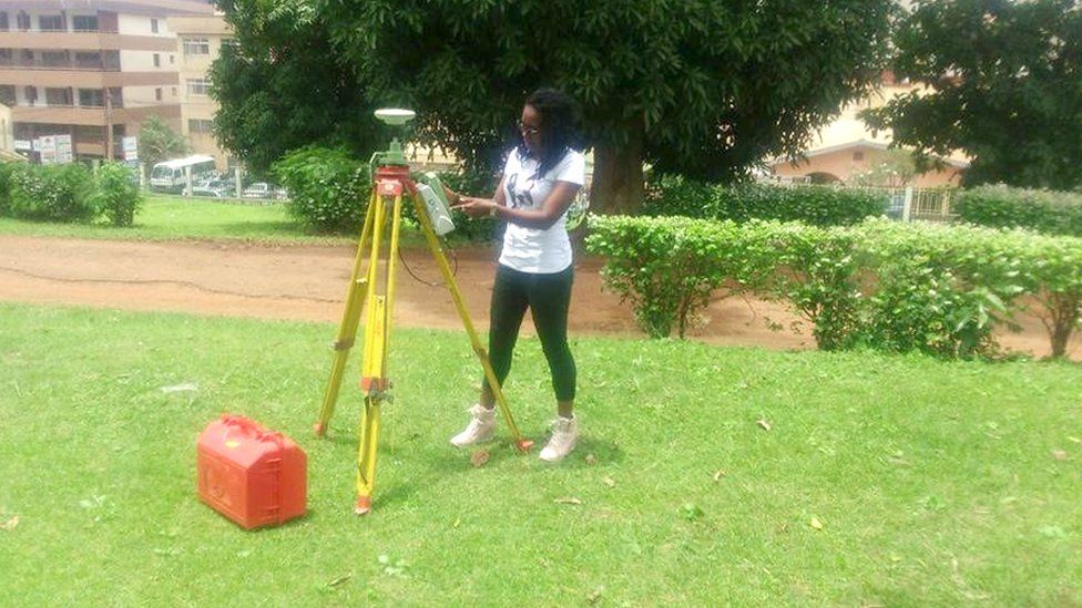 A woman using some equipment to take measurements