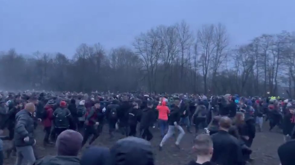 A crowd of people playing shrovetide football