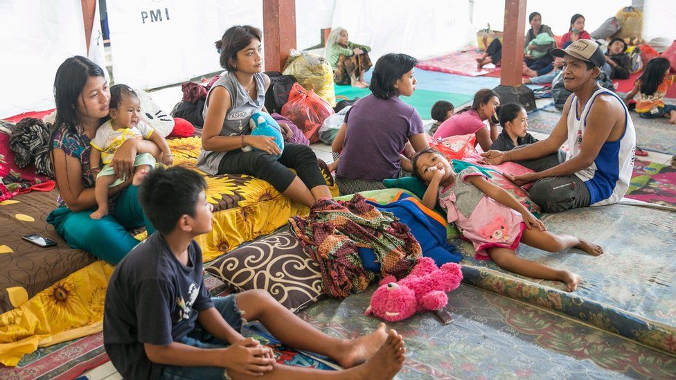 Evacuees stay at an emergency shelter as the Mount Agung volcano spews volcanic ash in Karangasem, Bali, Indonesia, 26 November 2017.