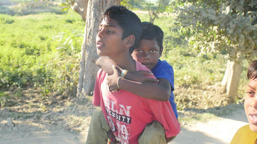 Akash being carried by his brother