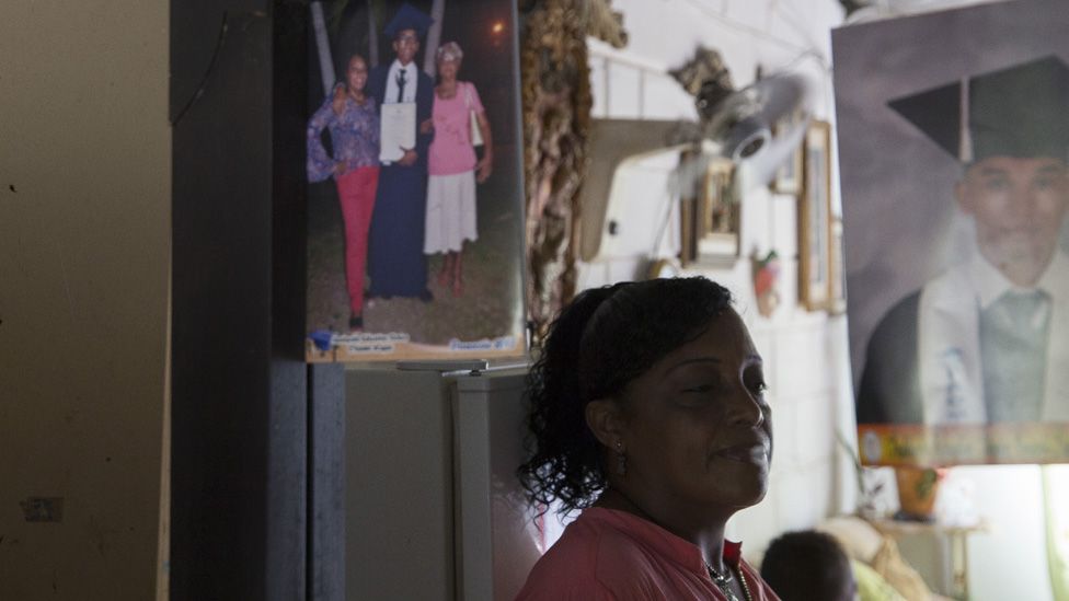 Alneris Orozco Caupo, 47, poses for a portrait in a mirror in her home in the City of Women