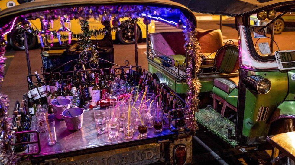 Bottles of wine are pictured in the back of a tuk-tuk during celebrations in Bangkok