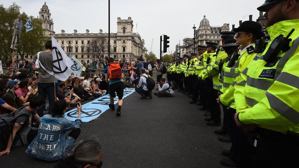 Police watch Extinction Rebellion protesters at their final destination of Parliament Square