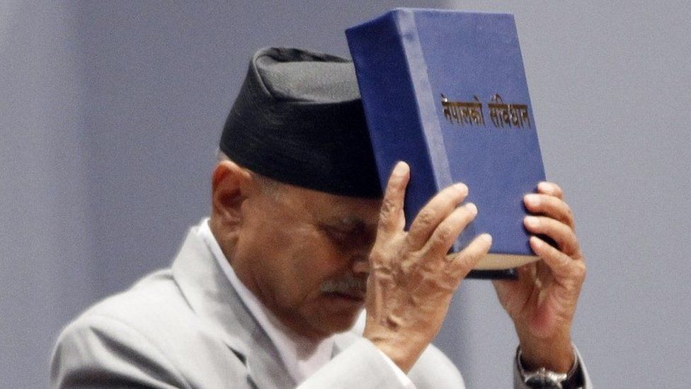 Nepalese President Ram Baran Yadav displays the constitution, formally adopted following a decade of political infighting, in Kathmandu, Nepal, Sunday, Sept. 20, 2015.