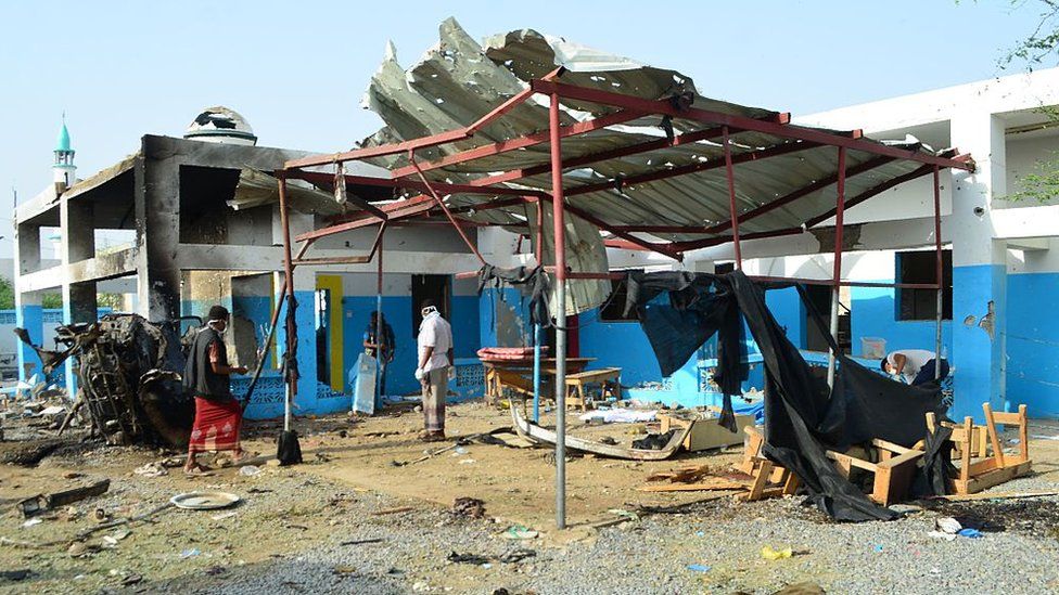 Men clear up at Abs hospital after it was hit by a Saudi-led coalition air strike (16 August 2016)
