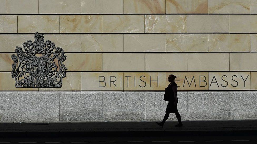 A woman walks past the UK embassy in Berlin