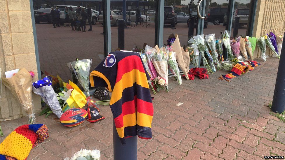 A memorial of flowers and football scarves and jerseys for Phil Walsh, outside the Adelaide Football club, 3 July 2015, South Australia