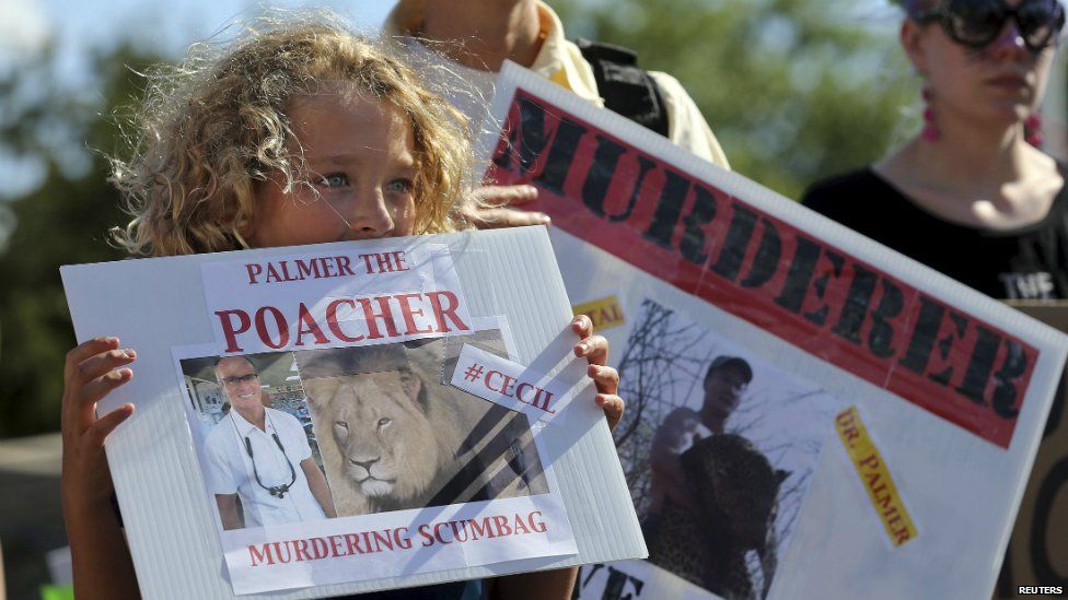 Protesters rally outside the dental clinic run by Walter Palmer in Minnesota - 30 July 2015