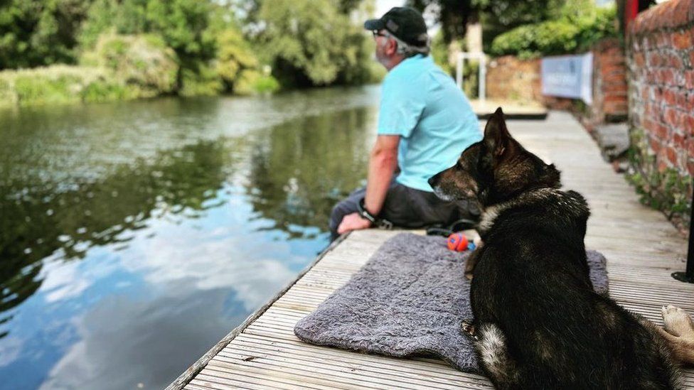 Dave Wardell and dog Finn by the river in Bedford