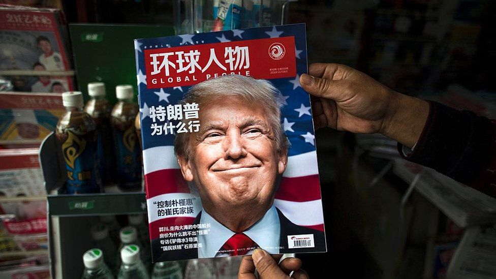 A copy of the local Chinese magazine Global People with a cover story that translates to 'Why did Trump win' is seen with a front cover portrait of US president-elect Donald Trump at a news stand in Shanghai on November 14, 2016.