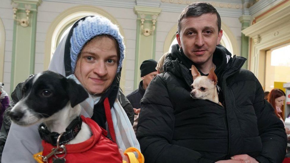 Refugees from Ukraine with their dogs are seen as they arrive at the railway station in Przemysl, eastern Poland