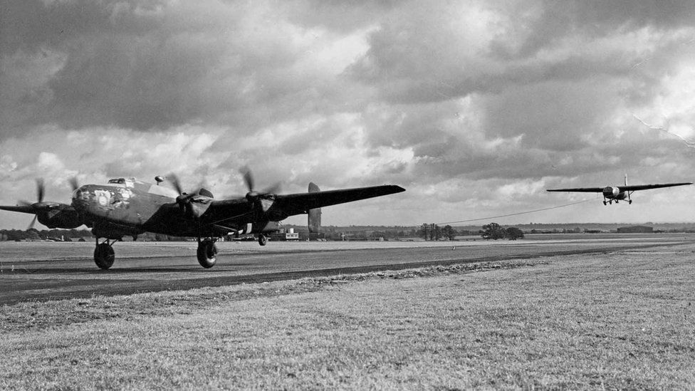 Black and white photo of a Halifax taking off towing a Horsa glider in 1944