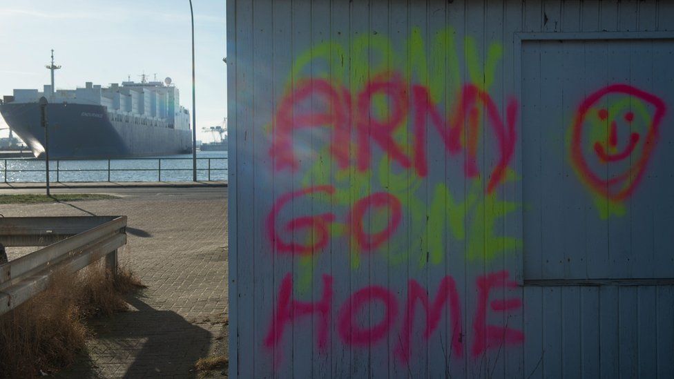 Graffiti at the port saying "army go home"