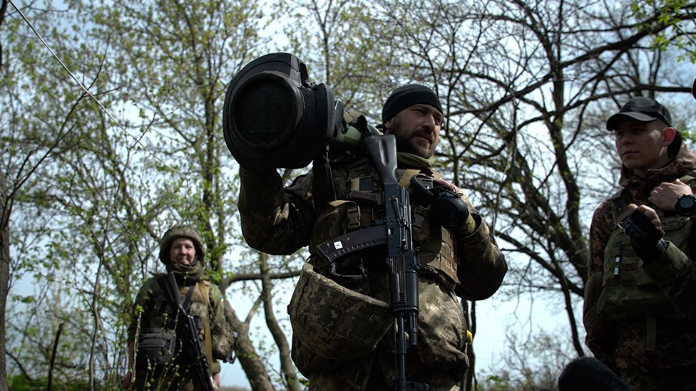 A Ukrainian soldier carries a UK made and supplied anti-tank missile