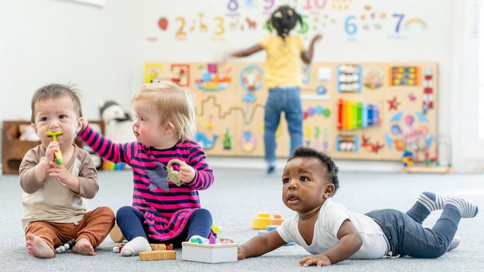 Four young children in a play room