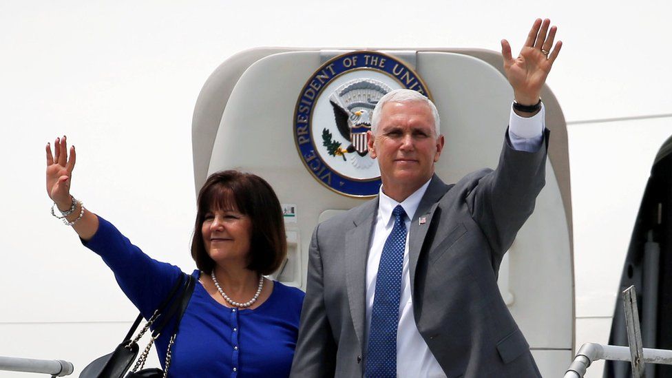 Mike Pence and his wife Karen wave for the cameras