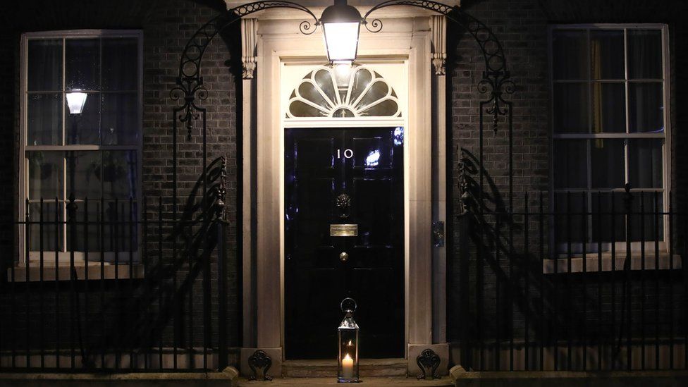 A candle is placed on the doorstep of 10 Downing Street, London