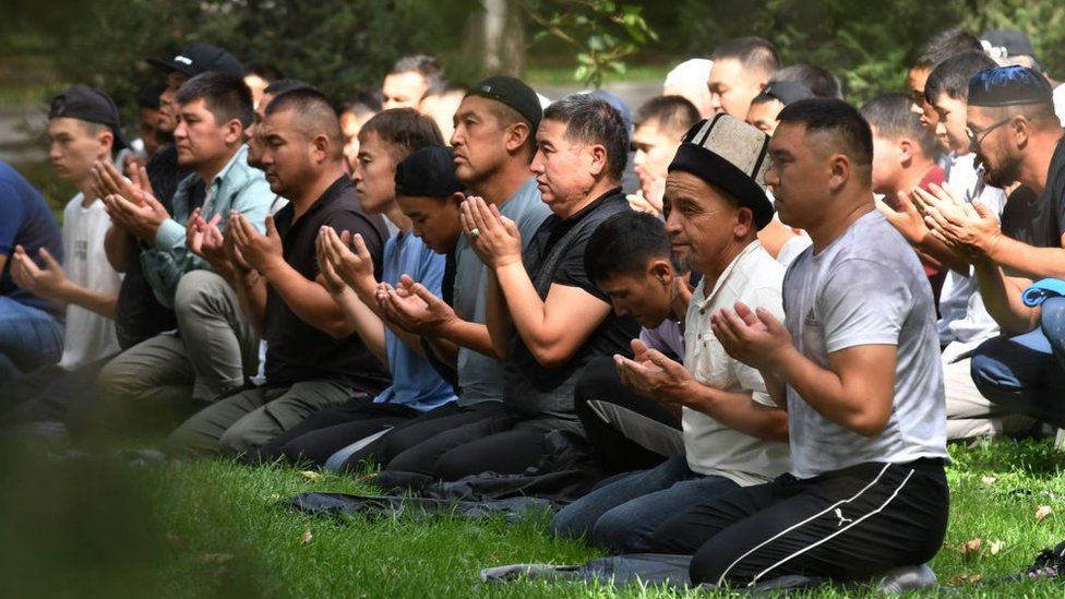 Protesters pray during a rally near the Kyrgyz parliament in Bishek on 16 September following clashes between Kyrgyzstan and Tajikistan