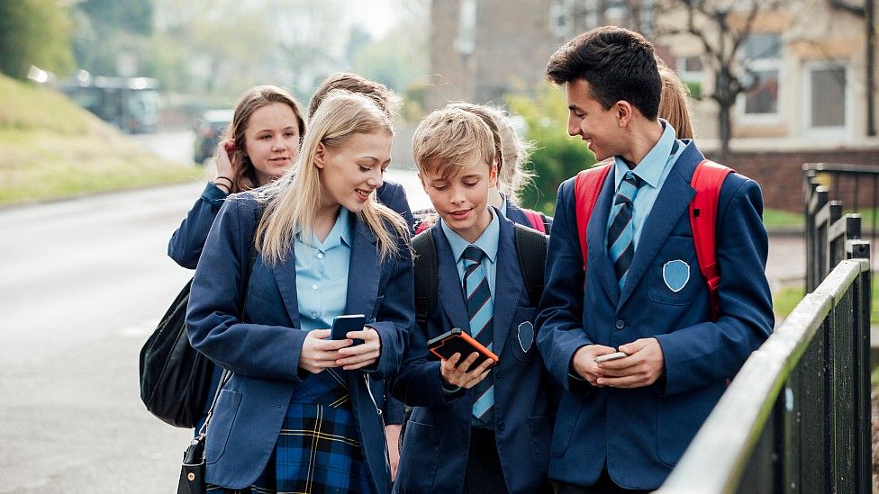 Schoolkids with phones