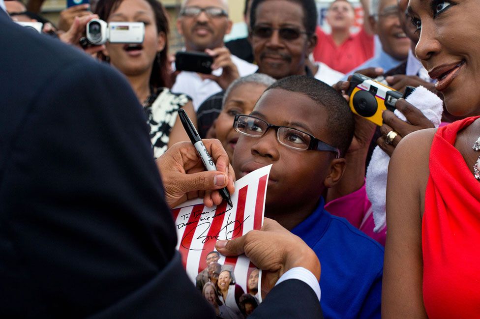 Obama signs an autograph in New Orleans in 2012