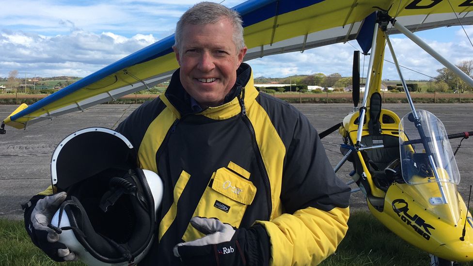 Willie Rennie holds a helmet after a microlight flight