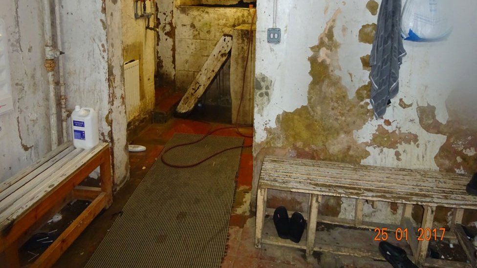 Ofsted picture of site used as unregistered school - derelict changing room with paint peeling off walls