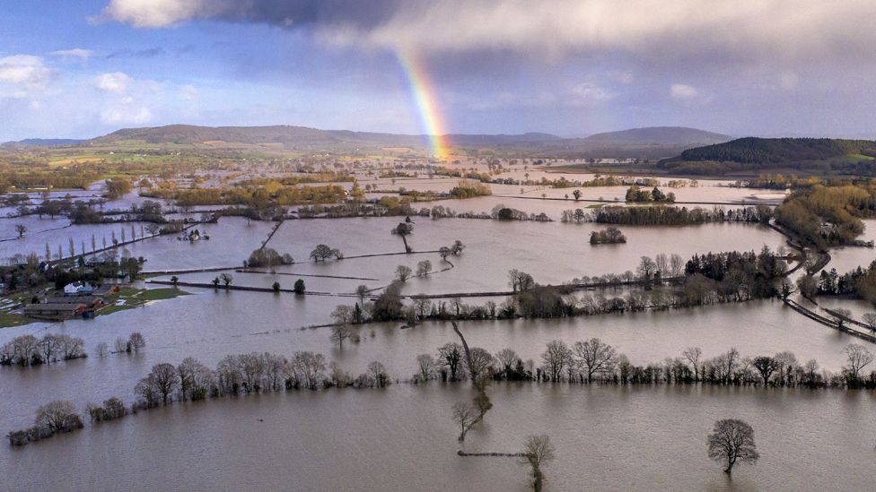 Rainbow over floodwater