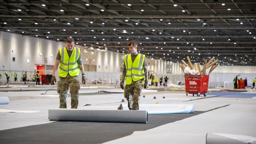 A hand-out picture provided by the British Ministry of Defence showing soldiers from 1 Royal Anglian Regiment as they assist with building the Nightingale Hospital at the ExCel conference centre in London