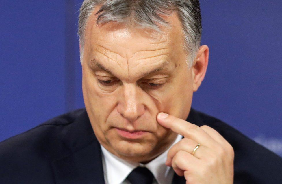 Hungarian Prime Minister Viktor Orban scratches his cheek as he attends a press conference at the end of the European People's Party (EPP) on 20 March