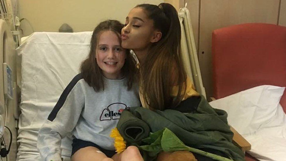 Ariana Grande with injured fan Evie Mills at the Royal Manchester Children's Hospital