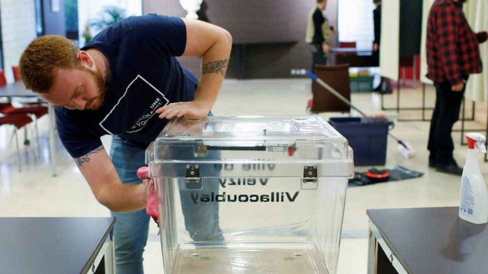 French employee cleans ballot box ahead of local elections - 14 March