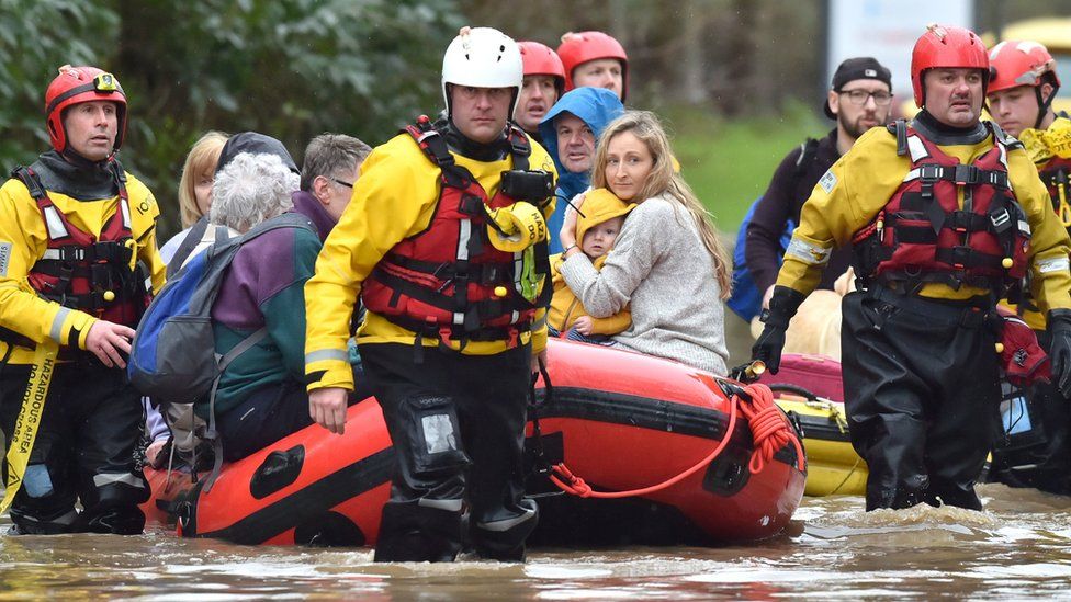 A rescue boat takes residents to safety in Nantgarw, near Cardiff