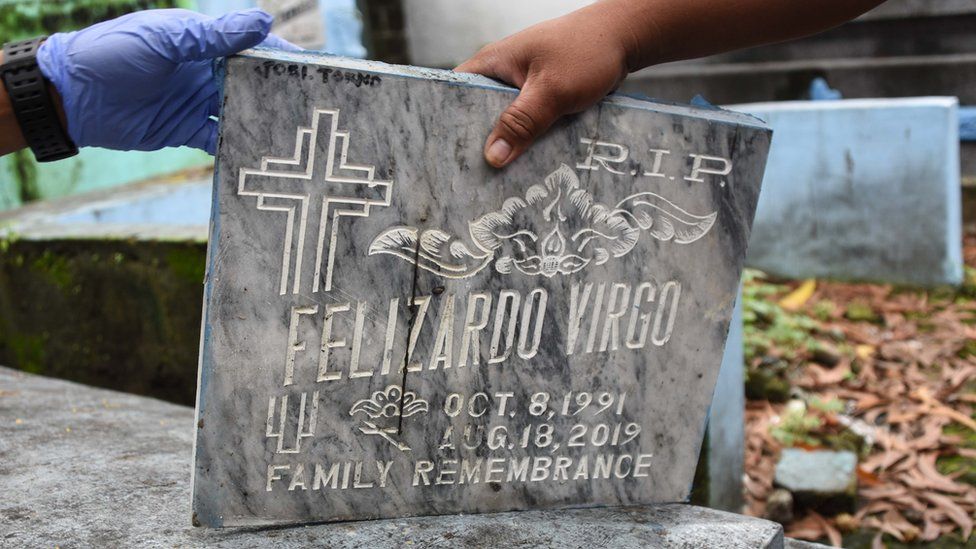 Tombstone of Duterte drug war victim Felizardo Virgo is removed at a cemetery in Manila