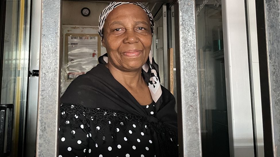 Woman looking through some bars