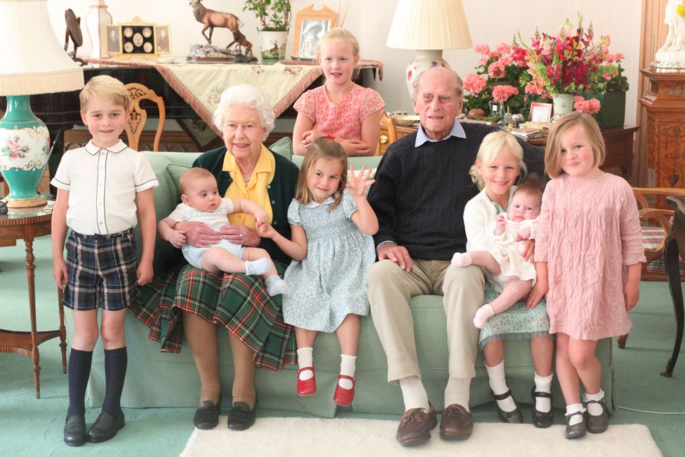 Pictured (left to right) Prince George, Prince Louis being held by Queen Elizabeth II, Savannah Phillips (standing at rear), Princess Charlotte, the Duke of Edinburgh, Isla Phillips holding Lena Tindall, and Mia Tindall. 14 April 2021