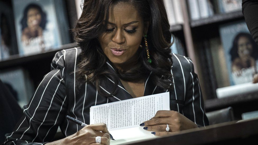 Former US First Lady Michelle Obama signs copies of her new book "Becoming" at a Barnes and Noble bookstore in New York City, 30 November 2018