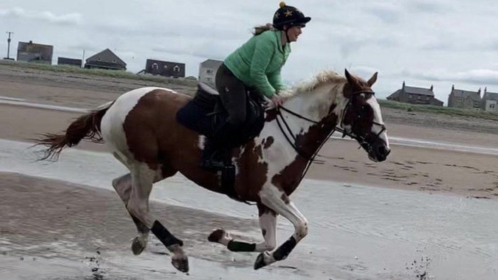 Francesca Kennedy rides Bart on a beach