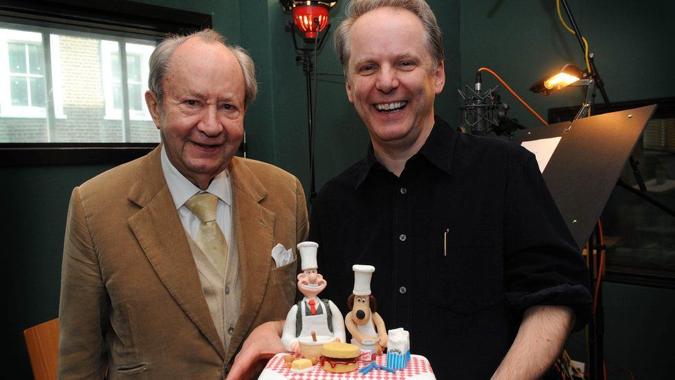 Peter Sallis and Nick Park with cake featuring Wallace and Gromit