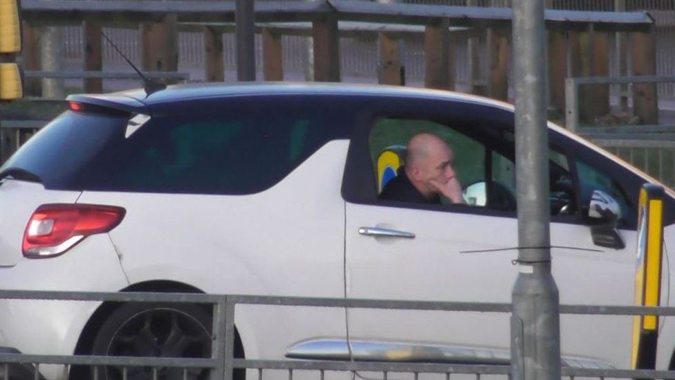 Lebek was pictured by police waiting to pick up a victim from Luton Airport