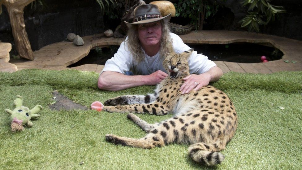 Iain Newby with his serval cat