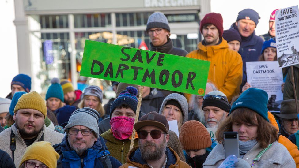 Protest with protestor holding up sign saying Save Dartmoor